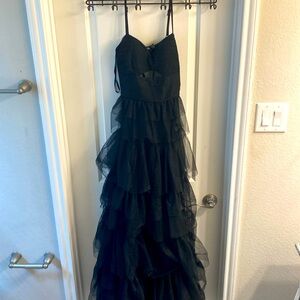 Gorgeous black ruffled ball gown with a upper belly cut out and open back size 3